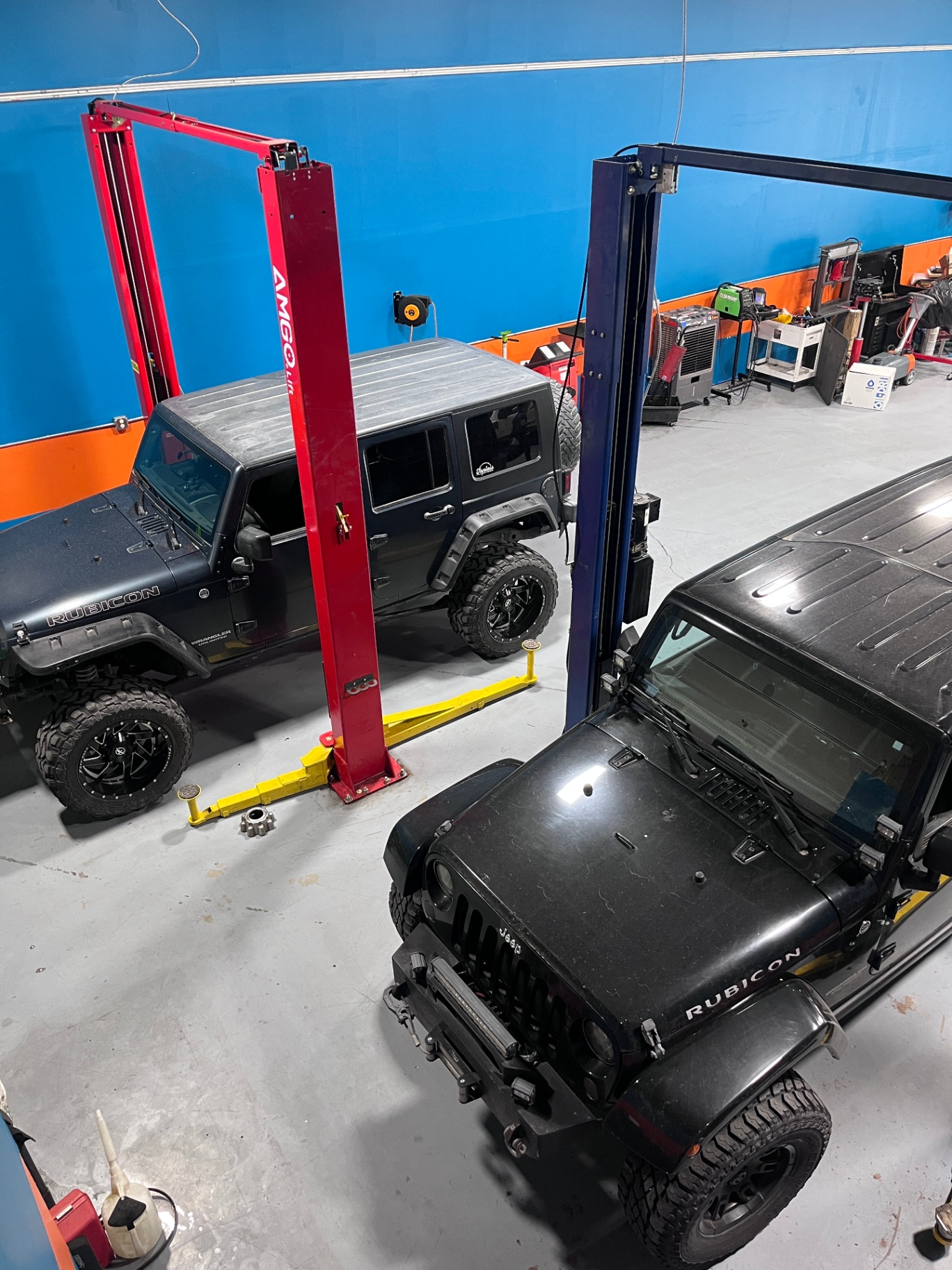 Jeep Wranglers on twin post lifts inside True North Automotive's shop bay